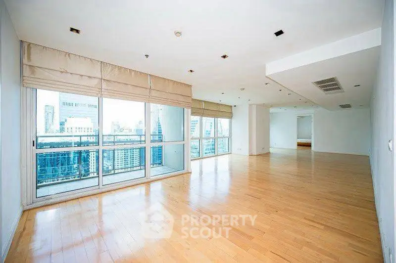 Spacious corner unit with floor-to-ceiling windows offering stunning city views and abundant natural light.