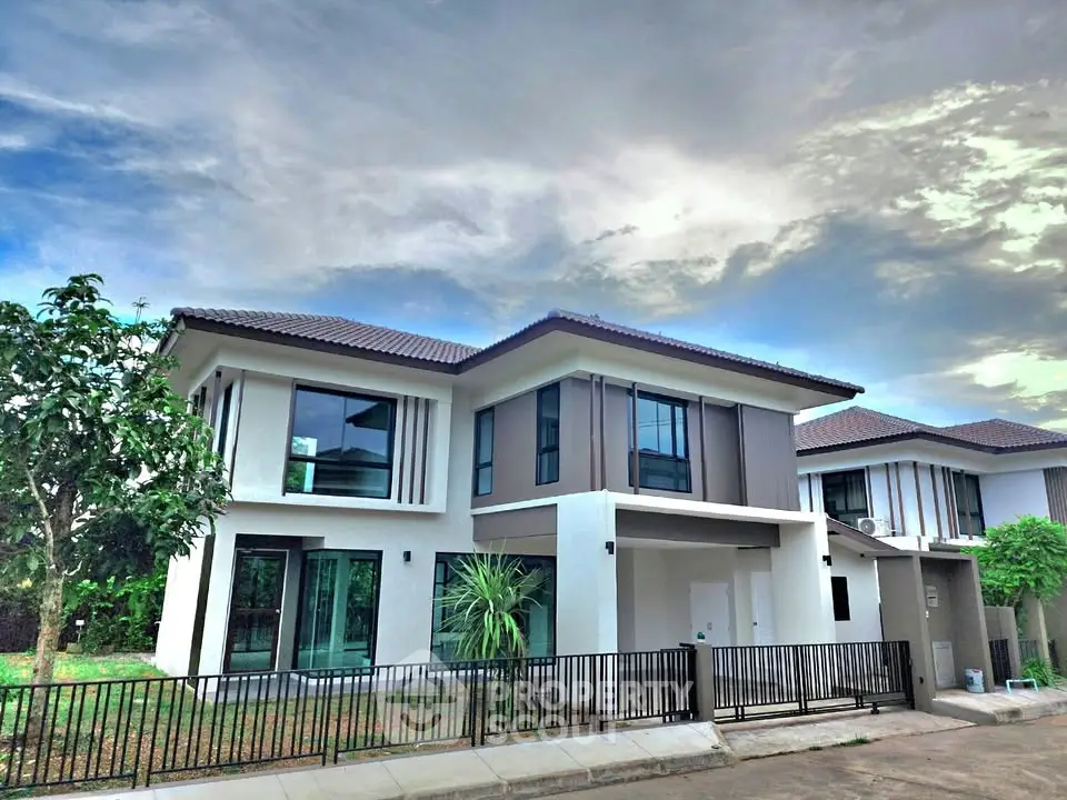 Modern two-story house with sleek design and spacious yard in a serene neighborhood.