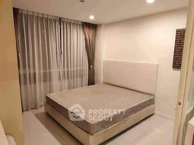 Modern bedroom with large window and stylish curtains in a contemporary apartment.