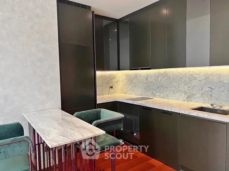 Modern kitchen with sleek cabinets and marble countertops in luxury apartment.