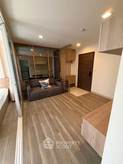 Modern living room with sleek wooden flooring and stylish furniture