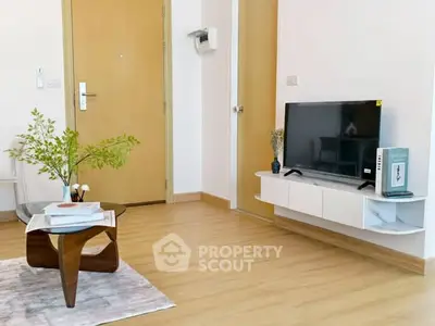 Modern living room with stylish furniture and mounted TV, showcasing minimalist design.