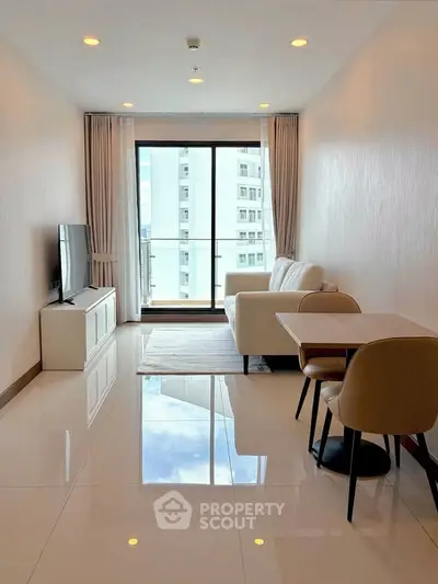 Modern living room with sleek furniture and large window offering city view