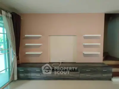 Modern living room with built-in shelves and sleek cabinetry, perfect for stylish home decor.