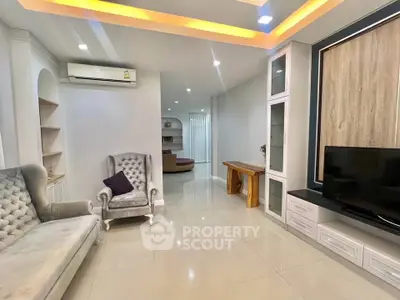 Elegant living room with plush seating and modern TV setup