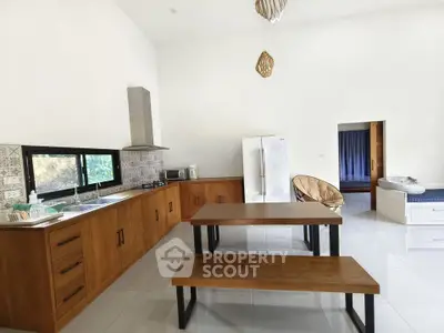 Spacious kitchen with wooden cabinets and dining area in modern home