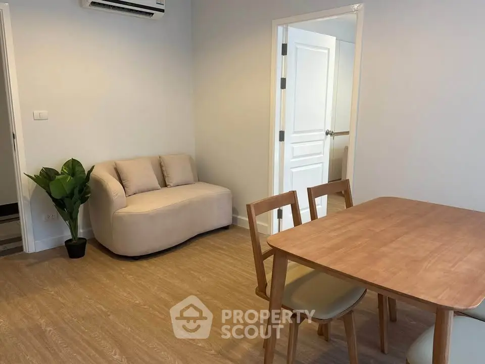 Cozy living room with modern furniture and wooden dining table