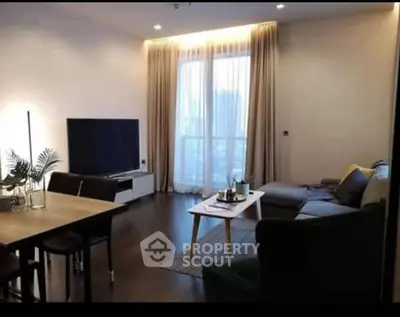 Modern living room with elegant decor and large TV, perfect for relaxation.