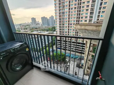 High-rise apartment balcony with city view and washing machine