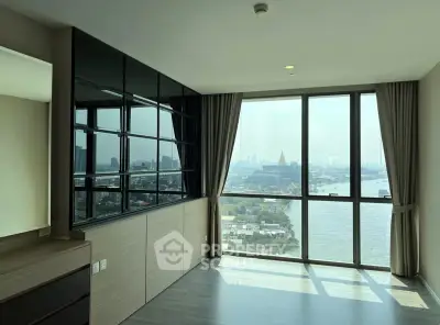 Spacious corner unit with stunning river view and floor-to-ceiling windows in modern apartment.