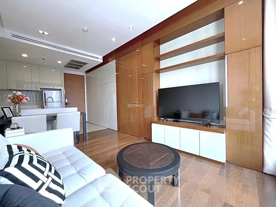 Modern living room with sleek design, open kitchen, and stylish furnishings in a luxurious apartment.