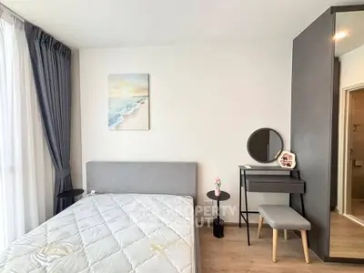 Modern bedroom with stylish decor and natural light, featuring a cozy bed and elegant furnishings.