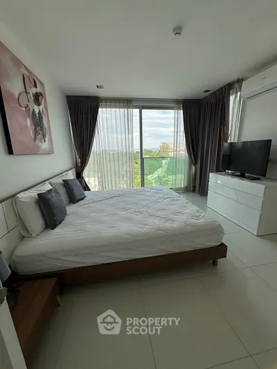 Modern bedroom with large window and scenic view, featuring stylish decor and natural light.