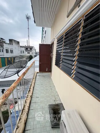 Charming balcony with city view, perfect for relaxation and enjoying the urban landscape.