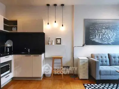 Modern living room with stylish kitchen and cozy seating area