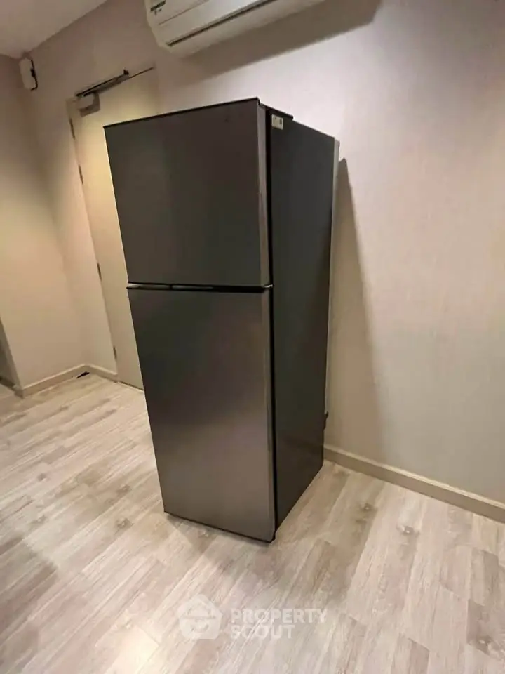 Modern kitchen with sleek refrigerator and stylish flooring