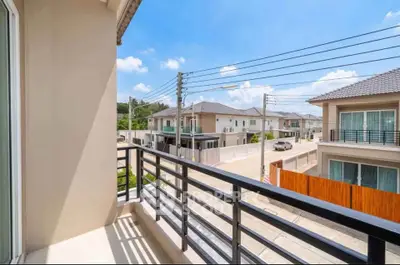 Charming balcony view of suburban neighborhood with modern houses and clear blue sky.