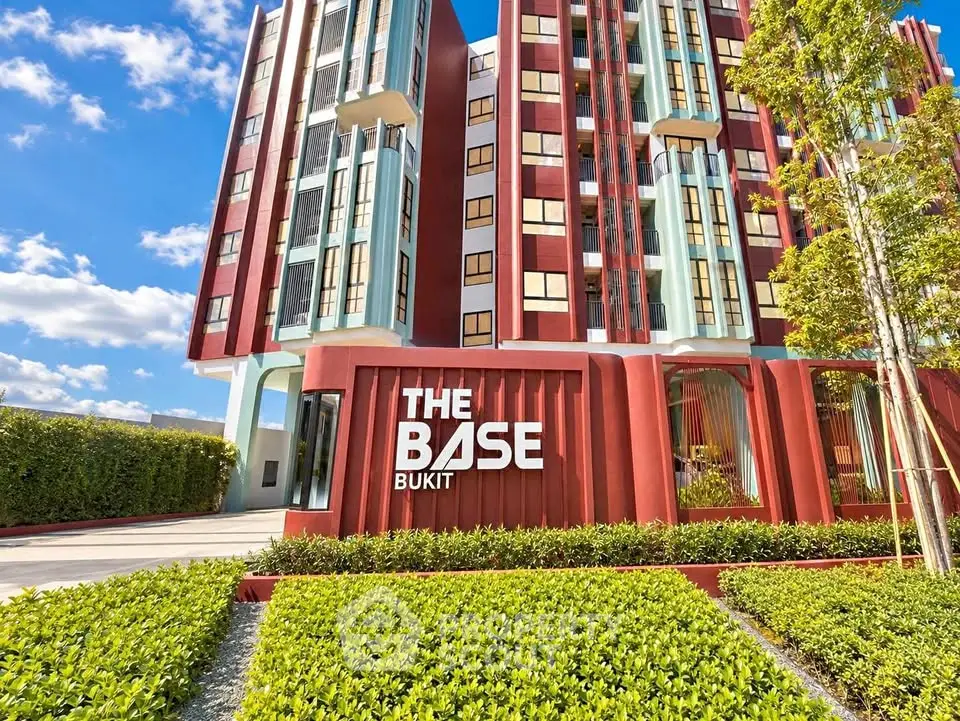 Modern residential building with vibrant facade and lush landscaping at The Base Bukit.