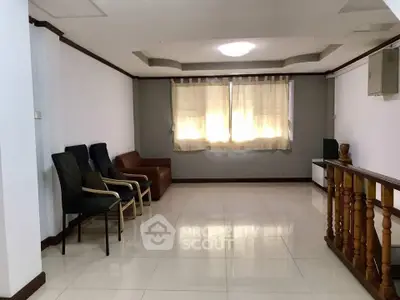 Spacious living room with modern chairs and natural light