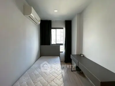 Modern minimalist bedroom with air conditioning and natural light