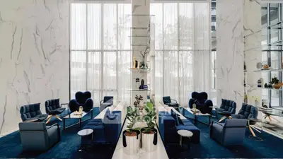 Luxurious modern living room with elegant blue seating and marble accents