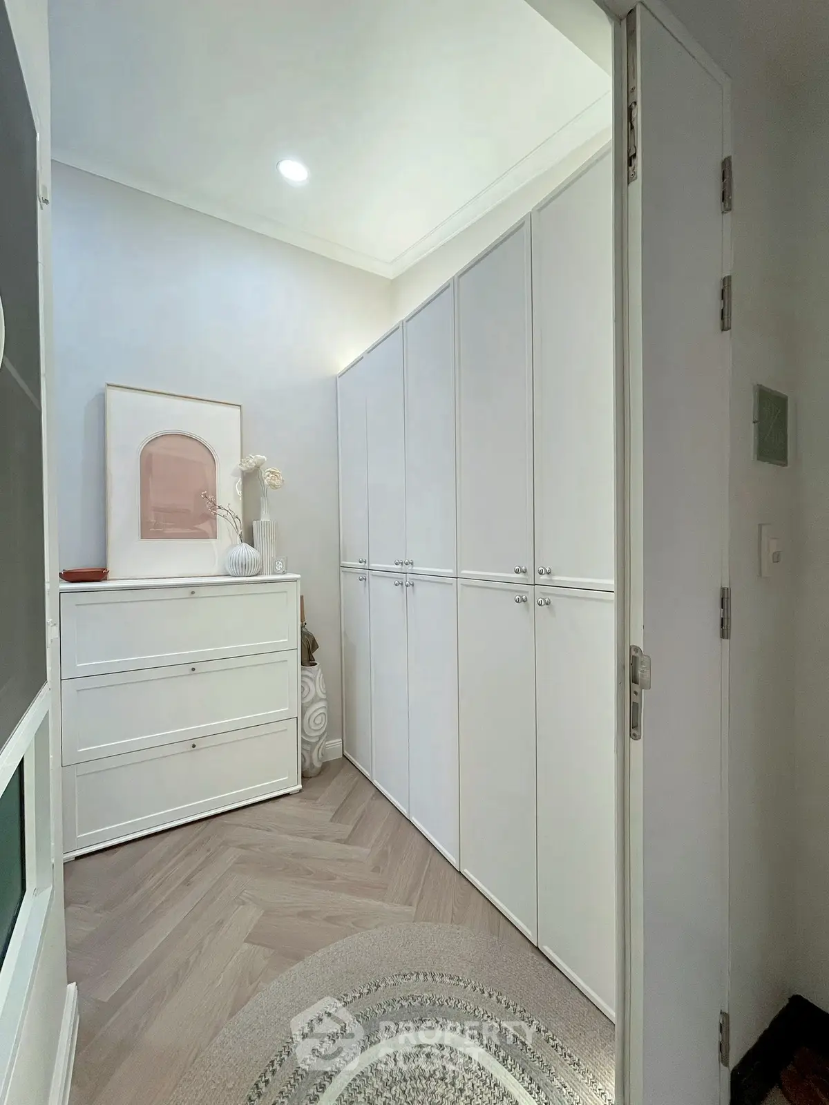 Elegant storage room with sleek white cabinets and modern decor