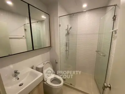 Modern bathroom with glass shower and sleek fixtures