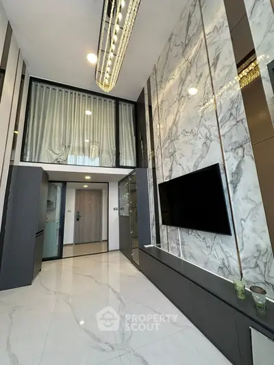 Luxurious modern living room with high ceiling and marble accent wall