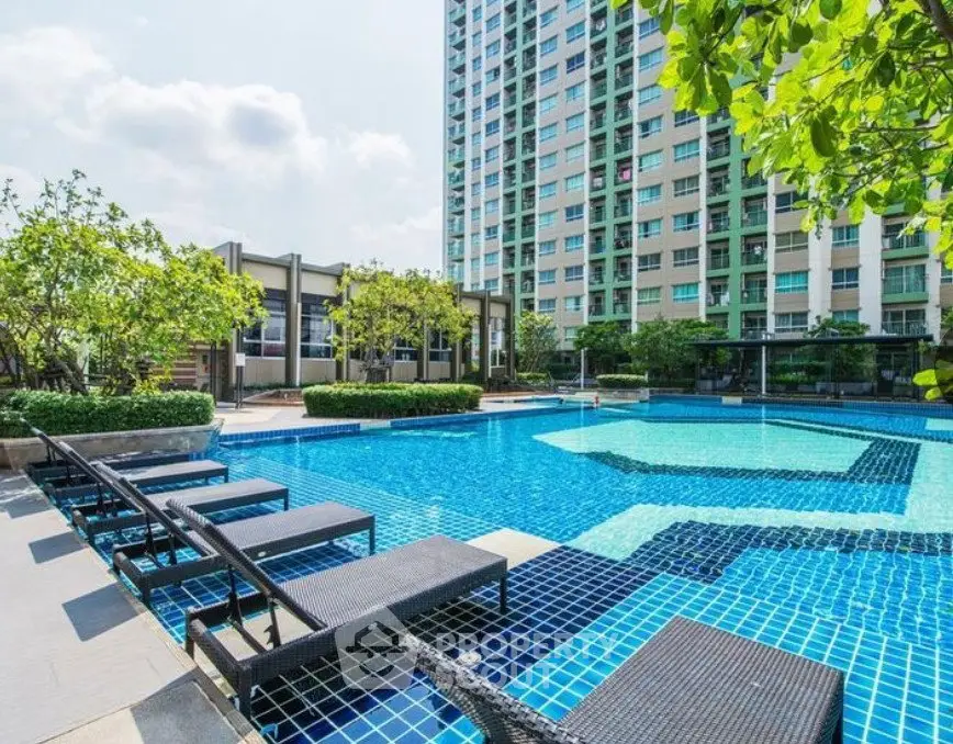 Luxurious condominium with stunning pool and lush greenery, perfect for relaxation and leisure.