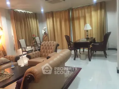 Luxurious living room with elegant furniture and warm lighting, perfect for relaxation and entertaining.