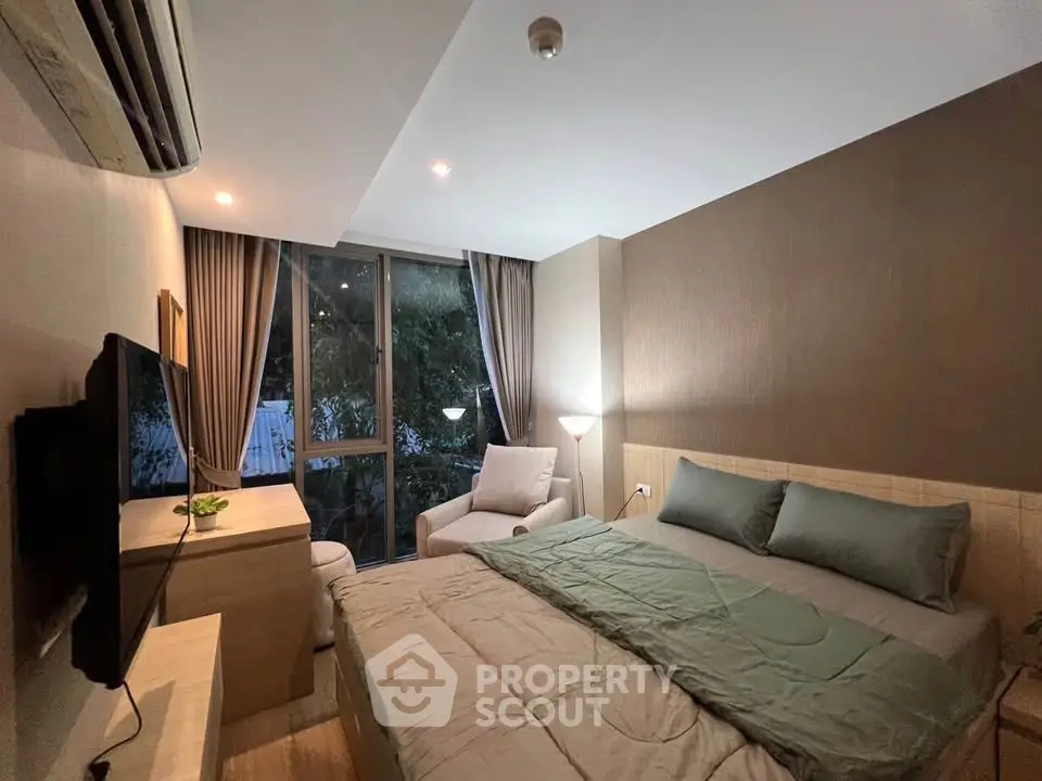 Cozy modern bedroom with large window and stylish decor