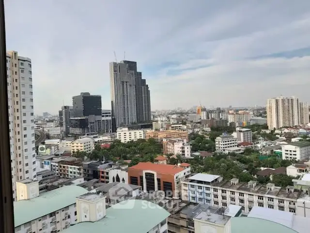 Stunning cityscape view from high-rise apartment showcasing urban skyline and modern architecture.