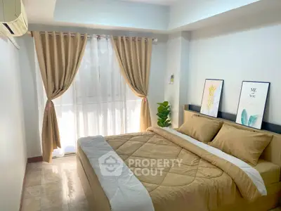 Cozy bedroom with natural light and modern decor, perfect for relaxation.