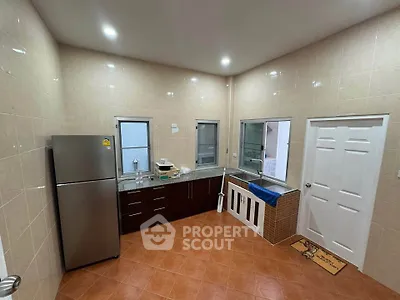 Spacious kitchen with modern appliances and ample counter space, perfect for culinary enthusiasts.