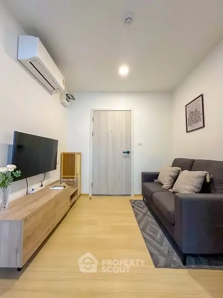 Modern living room with sleek furniture and air conditioning in a cozy apartment.