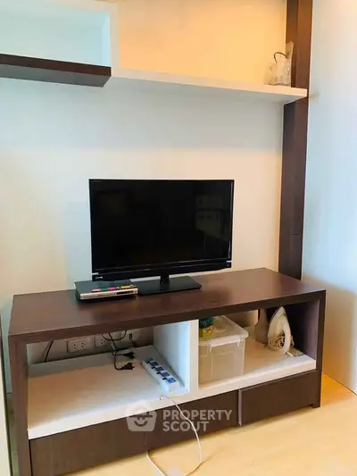 Modern living room with sleek TV stand and wall-mounted shelves, perfect for contemporary urban living.
