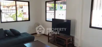 Spacious living room with modern furniture and large windows offering natural light.