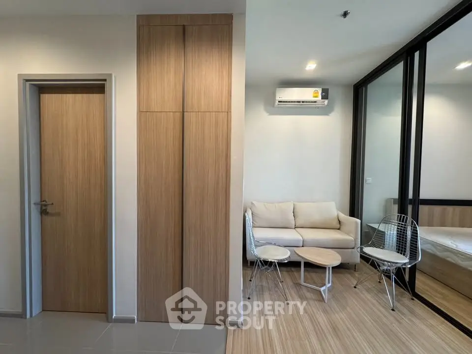 Modern living room with sleek furniture and air conditioning in a stylish apartment.