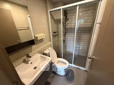 Modern bathroom with sleek shower and stylish fixtures in a contemporary apartment.