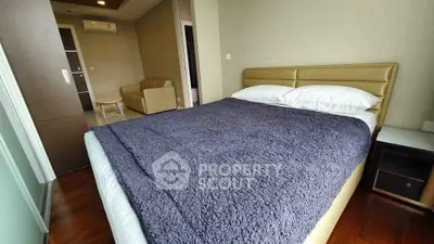 Spacious bedroom with cozy bed and modern furnishings in a stylish apartment.