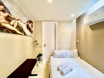 Cozy bedroom with modern decor and air conditioning, perfect for relaxation.