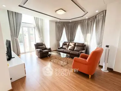 Spacious living room with modern furniture and large windows for natural light.