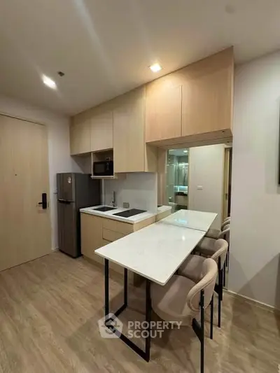 Modern kitchen with sleek design, featuring built-in appliances and a stylish breakfast bar.