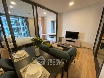 Modern open-plan living room with dining area and balcony view