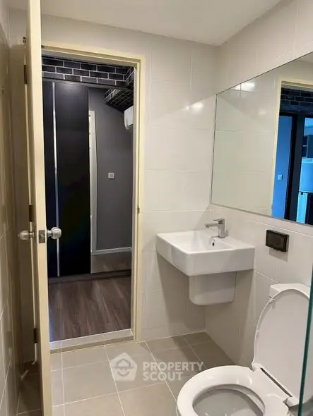 Modern bathroom with sleek fixtures and neutral tiles, offering a clean and contemporary design.