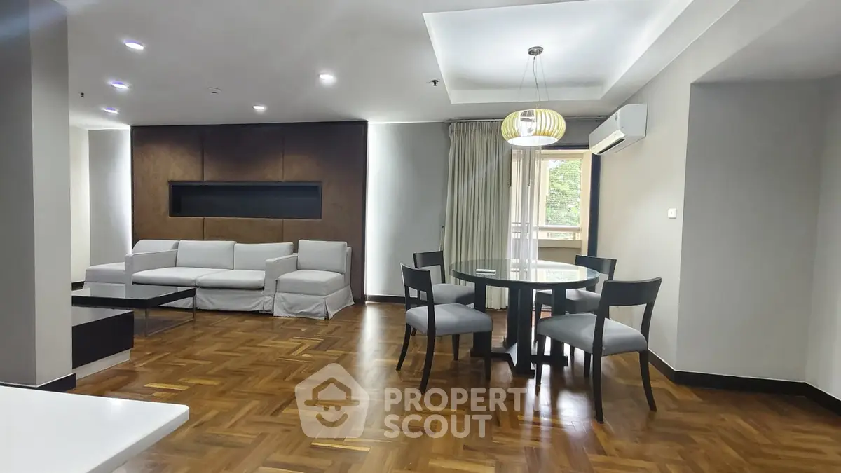 Spacious modern living room with elegant dining area and stylish parquet flooring.
