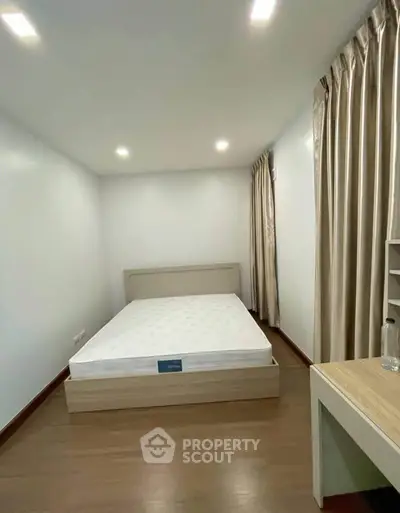 Spacious bedroom with modern decor and ample natural light