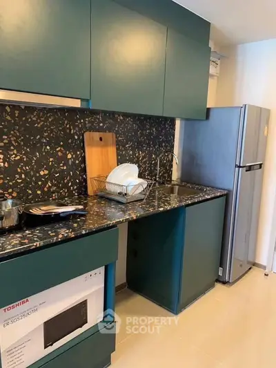 Modern kitchen with sleek cabinetry and stylish backsplash