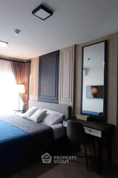 Elegant bedroom with modern decor and stylish furniture, featuring a cozy bed and a sleek vanity desk.