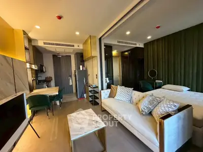 Luxurious modern studio apartment with elegant decor and open layout, featuring a cozy living area and stylish kitchen.
